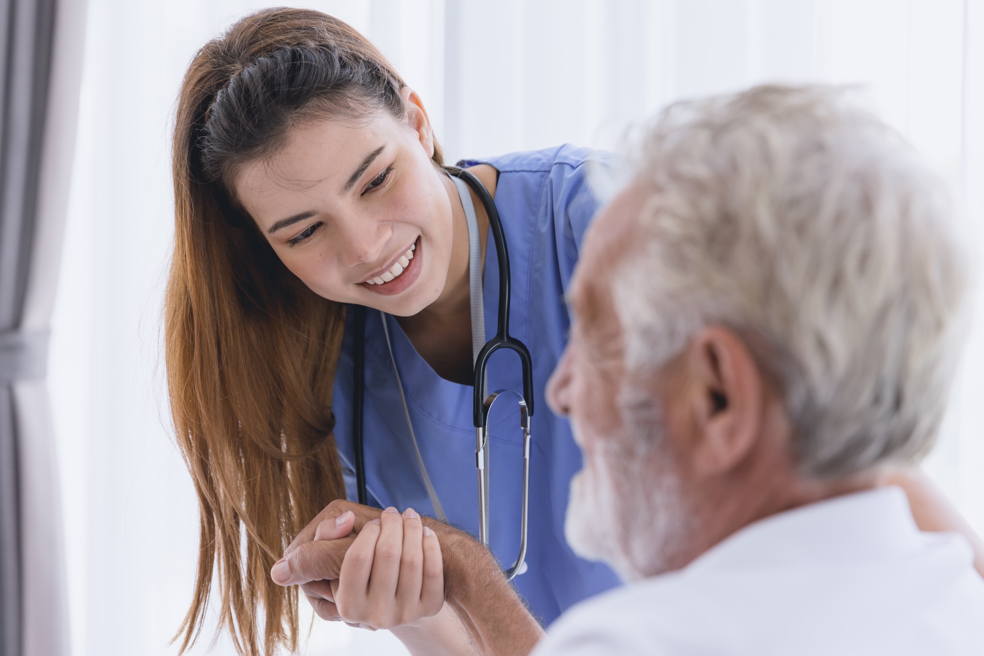 Nurse doctor working at home care medical checkup healthy elderly senior male happy smile